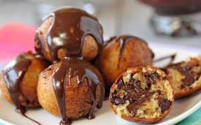 Plate of Puff Puffs covered in chocolate